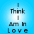 Blue gradient background with black text reading "I Think I Am In Love" arranged in vertical lines, displayed as a static image.