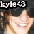 Pixelated image of a smiling person with light skin and brown hair, overlaid by white text reading 'kayla' on a black background.