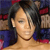 A pixelated close-up of a person with dark hair wearing a blue garment against a blurred background with red and blue tones.