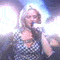 identical animated frames showing a woman with blonde hair singing into a microphone on stage under bright lights