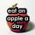 A red apple with a green stem and shadow appears in four , each displaying different text overlays