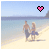 A pixelated beach scene shows two people walking on sand near water, with a heart symbol above them changing color.