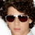 A person with curly brown hair and dark red sunglasses appears in four -aligned , each showing a slightly different head position against white backgrounds