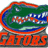 Pixelated green alligator head with red outline and white teeth, below which orange 'GATORS' text appears on blue background.