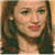 A pixelated image of a person with long brown hair and light skin, next to green text on a dark background.