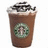 Brown beverage cup with green circular logo, white foam, and dark sprinkles on top, displayed in a