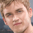 A pixelated image of a person with light brown hair on the left, next to a red background with black text reading 'i love NEIL!!' on the right.