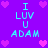 Pixelated purple background with cyan text "I LUV U ADAM" repeated in four quadrants, surrounded by pink heart icons.