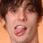 Pixelated close-up of a person's face with dark hair, showing mouth open in mid-expression against light background.