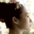 Pixelated close-up of a person's profile with dark hair, light skin, and a neutral expression against a bright background.