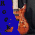 A pixelated image of an orange electric guitar with black and white accents, partially overlaid by blue shapes containing text elements.