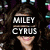 A pixelated image of a person with long brown hair, showing four distinct text overlays across different sections of the face and body.