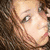 A pixelated image of a person with brown hair on the left, and four blue text phrases on bright pink backgrounds arranged in a
