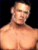 Pixelated image of a shirtless man with short hair against black background, accompanied by blue and pink pixelated text.