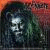 Pixelated static image of a stylized face with dark hair and red background elements, likely representing a musician or band member from the late 1990s/early 2000s digital art style.