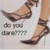 A pixelated image shows a person's legs in high-heeled shoes with visible skin tone and dark straps, standing against a light background.