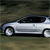 Pixelated side view of a silver sedan with black windows and wheels on a blurred greenish background.