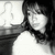 Black-and-white pixelated image of a person with dark hair and a white shirt, partially cropped on the left side.