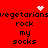 Red background with black text repeating 'vegetarians rock my socks' in two , white pixelated heart and starburst symbols above the top