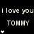 Pixelated text and symbols on black background with repeated 'i love you' lines, three 'TOMMY' labels, and star-like asterisks in varying configurations.