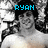 A black-and-white image of a shirtless person with long hair, featuring blue text overlays and pixelated background elements.