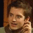 A pixelated image of a person with brown hair holding their hand near their face, next to green text reading 'Original Icons .com' on a dark background.