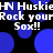 Blue circular shapes float over a black background with repeated white text reading 'HN Huskie Rock your Sox!!' in pixelated font.