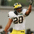 Pixelated image of a football player in white jersey with number 20 and yellow helmet, standing next to text displaying UM 41 and UF 35.