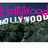 A Hollywood sign with changing pink text overlays on a blue sky background.