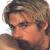 A pixelated image of a person with light brown hair and fair skin, positioned next to green text on a dark background.