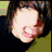 A person with brown hair and a black top appears in the image.