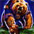Pixelated static image of a brown bear mascot in blue sports uniform holding a football, standing on green grass against dark blue background.