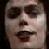 Static image with red text on black background featuring a person's face and the phrase 'Dr. Frank-n-Furter Give Yourself Absolute Pleasure' in pixelated font.