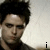 nine pixelated frames showing a person with dark tousled hair against a light textured background, with text overlays changing across the sequence