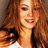 Static 48x48 pixel icon showing a close-up of a person with long brown hair wearing a white top and dark straps, rendered in low-resolution pixelation with warm color tones.