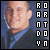A pixelated image of a person in a dark jacket and blue shirt with vertical text reading 'ROARNTDOON' on the right side, shown in two states where the text changes from black to light blue.