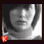 Black-and-white profile photo of a person with short dark hair and light clothing, displayed in a with red heart-shaped icons containing letters