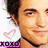 Pixelated close-up of a person with dark hair and light skin wearing a white shirt, featuring pink heart symbols and purple text at the bottom.