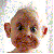 Pixelated static image of a cartoonish face with large eyes, brown skin tones, and red ears against a light background.
