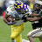 Animated sequence showing a football player in yellow pants and silver helmet with changing text overlays: GO, MIKE, HEART.