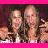 Two women pose together in a pixelated image with pink borders, one making a peace sign.