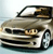 Pixelated image of a silver sedan with a black roof, front-facing view showing headlights, grille, and wheel, set against a light blue background.