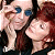 A 50x50 pixel animated contact sheet showing two frames of a buddy icon featuring two people with red hair and blue eyes on the left, next to green text reading "Original Icons .com" on a dark green background.