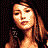 Pixelated image of a woman in a dark red strapless top with a deep neckline, standing against a black background with text reading Coolbuddy.com.