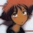 Pixelated static image of a character with dark hair and orange skin tones, wearing a dark jacket against a light background.