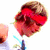 A person with brown hair and a red headband appears in three showing slight movement of the head and mouth