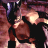Pixelated static image of a character in dark clothing with light-colored hair and partial facial features, set against a dark background with purple and pink tones.