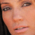 Close-up of a person's face with light skin tone, visible eyes, nose, mouth, and dark hair on the left side.
