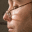 A static composition with text and two distinct images of a man with glasses, one showing a side profile and the other a front view.