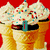 Pixelated ice cream cone with white frosting and colorful sprinkles on a red background, featuring text overlays.